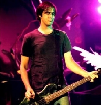 In the photo is shown Krist Novoselic, he's holding a guitar and singing